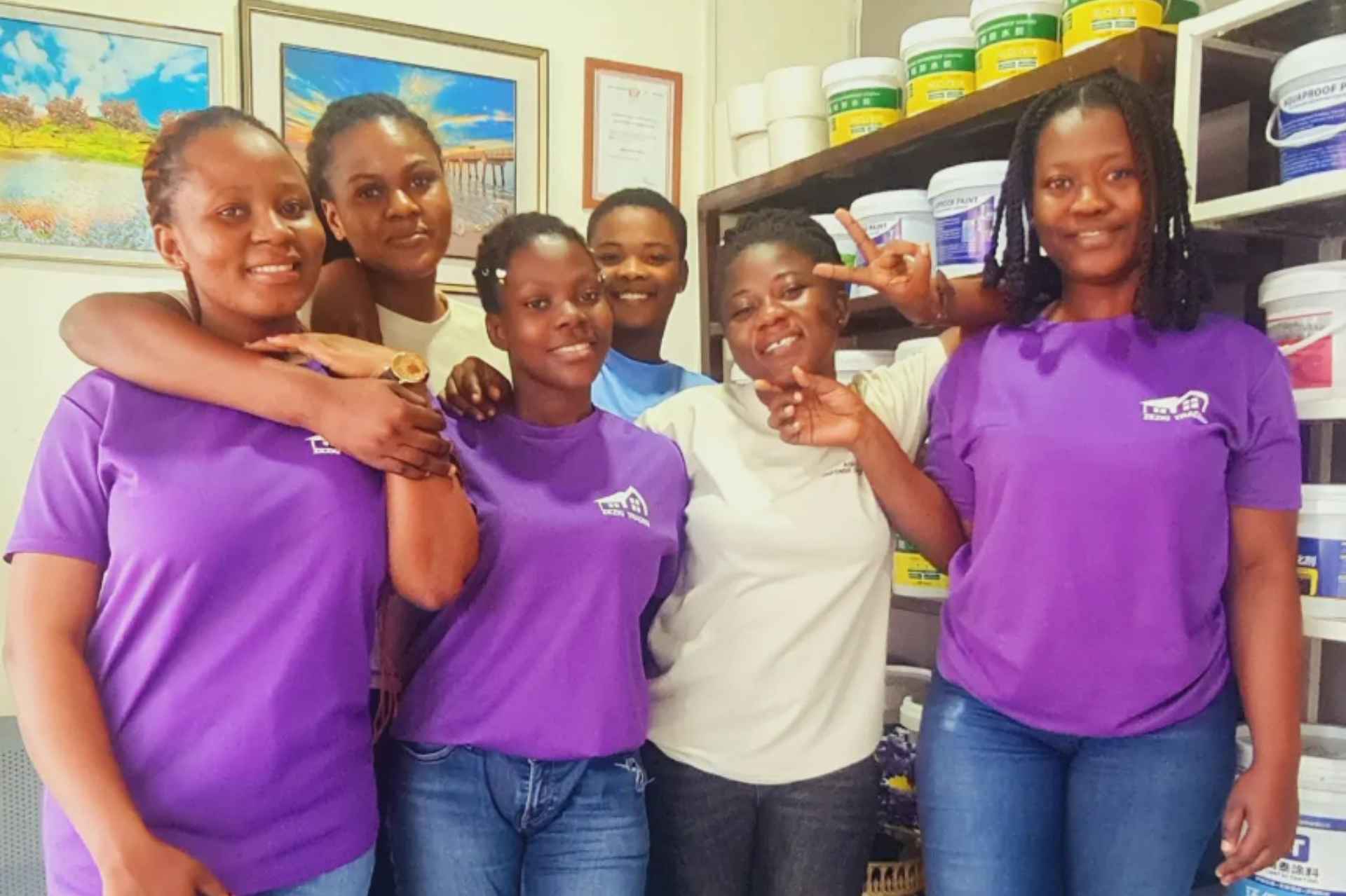 The Aqua Defence Services team in front of shelves of waterproofing products